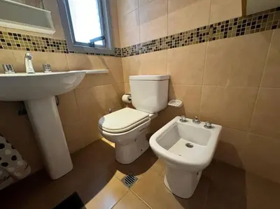 a bathroom with a toilet and a sink at Departamento Céntrico in Cordoba