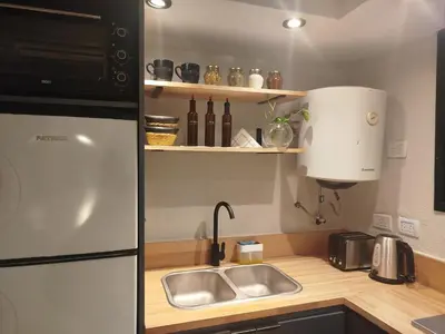 a kitchen with a sink and a refrigerator at Funes Departamento céntrico un dormitorio Solo turistas in Cordoba