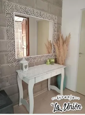 a white vanity with a mirror on a wall at Granja La Unión in Villa Dolores