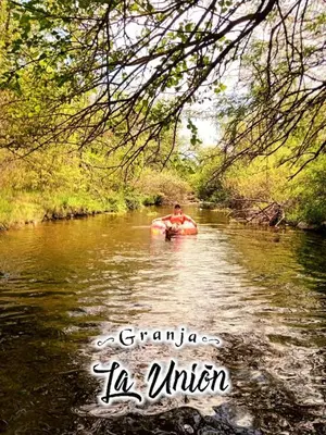 a man in a raft in a river at Granja La Unión in Villa Dolores