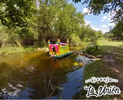 a group of people riding a small boat in a river at Granja La Unión in Villa Dolores