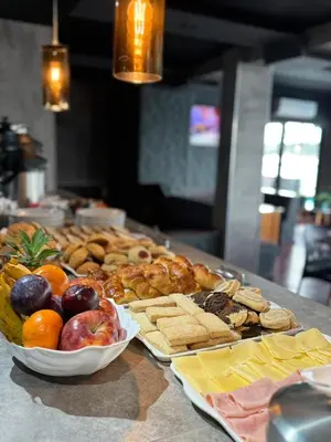 a table with a bunch of different types of food at Ciervo de Oro in Villa Carlos Paz