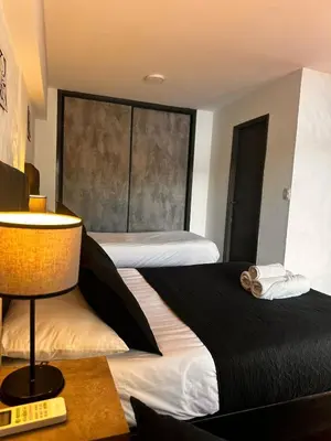 a hotel room with two beds and a window at Ciervo de Oro in Villa Carlos Paz
