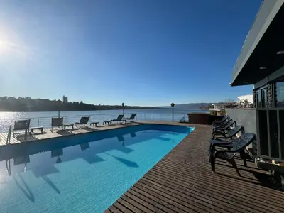 a swimming pool with chairs and the water at Ciervo de Oro in Villa Carlos Paz