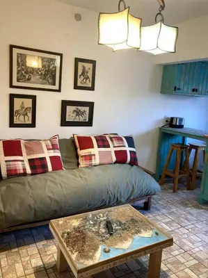 a living room with a couch and a table at Casita Sirio in Mina Clavero