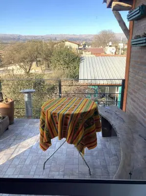 a table with a blanket on a patio at Casita Sirio in Mina Clavero