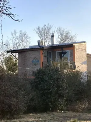a small brick house with a window on it at Casita Sirio in Mina Clavero
