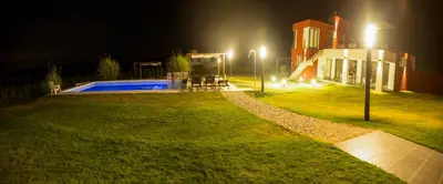 a house with a swimming pool at night at Colinas de Nono in Nono