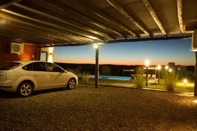a white car parked under a garage at night at Colinas de Nono in Nono