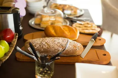 a table topped with bread and other pastries on cutting boards at Colinas de Nono in Nono