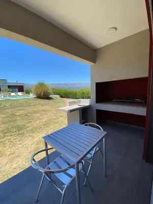 a blue table and a chair on a patio at Colinas de Nono in Nono