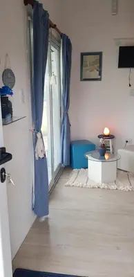a room with a window with a blue curtain at Tiny Samay Punto Claro in Villa Ciudad Parque