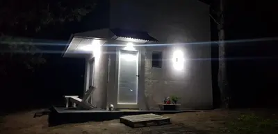 a house with a lit up door at night at Tiny Samay Punto Claro in Villa Ciudad Parque