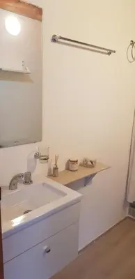 a white bathroom with a sink and a mirror at Tiny Samay Punto Claro in Villa Ciudad Parque