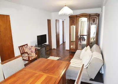 a living room with a couch and a table at Departamento lindo y cálido in Cordoba
