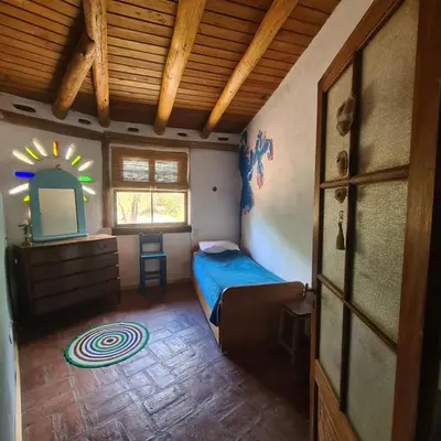 a bedroom with a bed and a dresser and a mirror at Casa de Monte in Cerro de Oro
