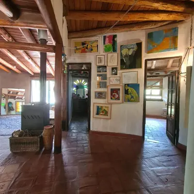 a room with paintings and pictures on the walls at Casa de Monte in Cerro de Oro
