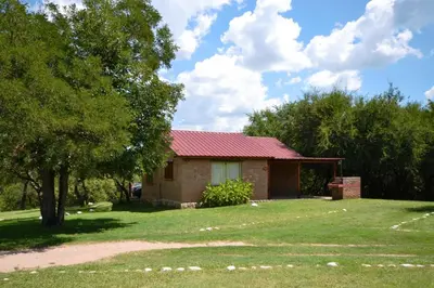 a small brick house with a red roof at El Viejo Molino Casas de Campo in Nono