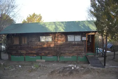 a small log cabin with a green roof at Cabaña Waicol EXCLUSIVA in Potrero de Garay