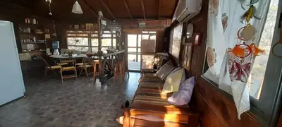 a living room with a couch and a dining room at Cabaña Waicol EXCLUSIVA in Potrero de Garay