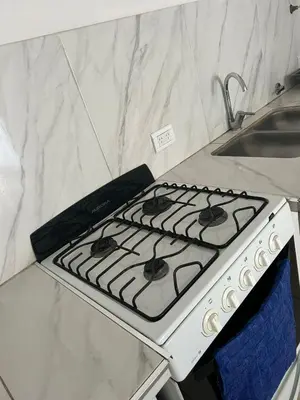 a white stove top oven in a kitchen at Depto1 in Río Cuarto