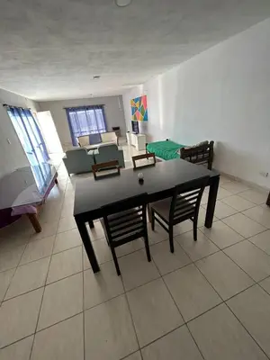 a living room with a black table and chairs at Depto1 in Río Cuarto