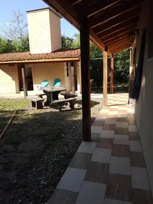 an outdoor patio with a picnic table and chairs at Dormis Clave de Sol -dos in Villa Ciudad Parque