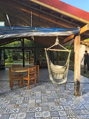 a hammock and a table and chairs under a pavilion at Dormis Clave de Sol -dos in Villa Ciudad Parque