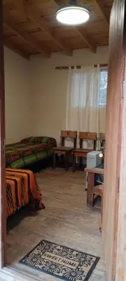 a room with a bed and a couch and a table at Dormis Clave de Sol -dos in Villa Ciudad Parque