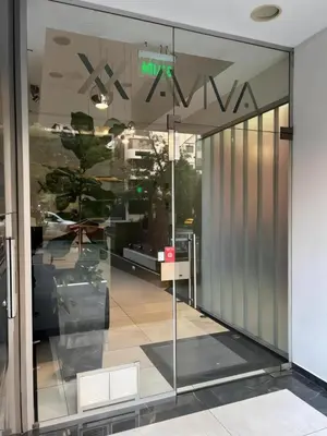 an entrance to a building with a glass door at IBBA - Departamento en Nueva Cordoba con pileta in Cordoba