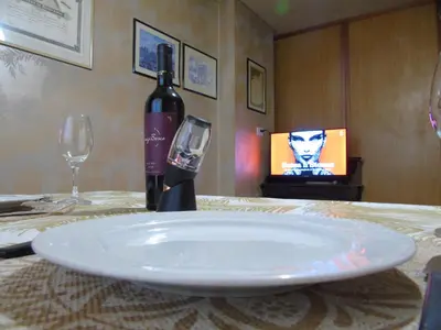 a bottle of wine sitting on a table with glasses at Córdoba Centro Gran Ubicación Gran Vista in Cordoba
