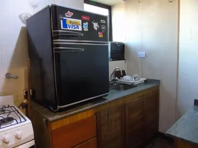 a kitchen with a black refrigerator and a stove at Córdoba Centro Gran Ubicación Gran Vista in Cordoba