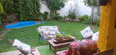 a patio with two chairs and a table with a potted plant at La bien querida in Cordoba