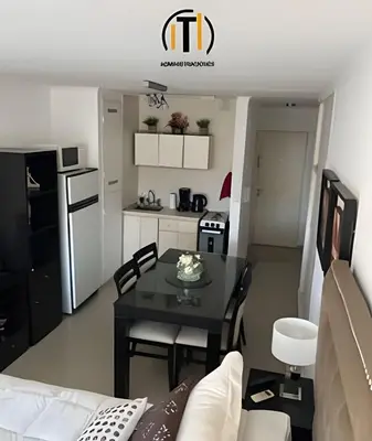 a living room with a table and a kitchen at Apartament vista Buen pastor in Cordoba