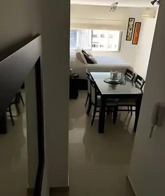 a living room with a table and a couch at Apartament vista Buen pastor in Cordoba