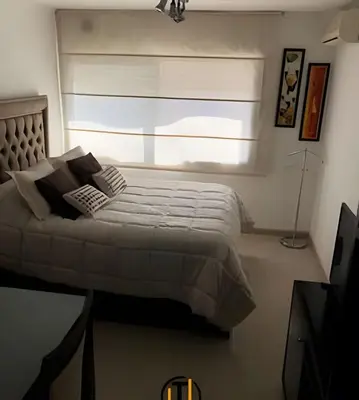 a bedroom with a large bed with a window at Apartament vista Buen pastor in Cordoba