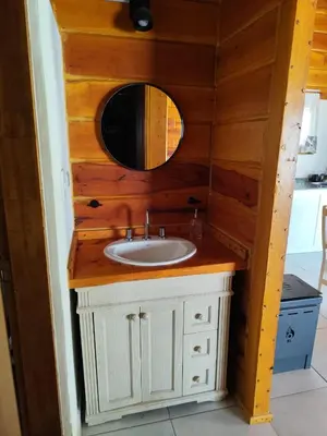a bathroom with a sink and a mirror at Los Grillos Cabañas Serranas in Los Reartes