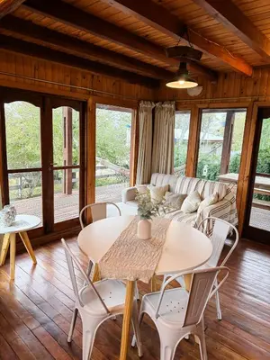 a living room with a couch and tables and chairs at Casa Mona in Potrero de Garay