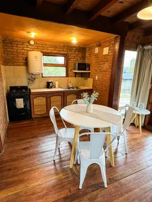 a kitchen and dining room with a table and chairs at Casa Mona in Potrero de Garay