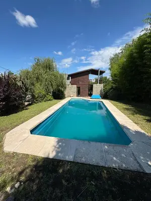 a swimming pool in the yard of a house at Casa Mona in Potrero de Garay
