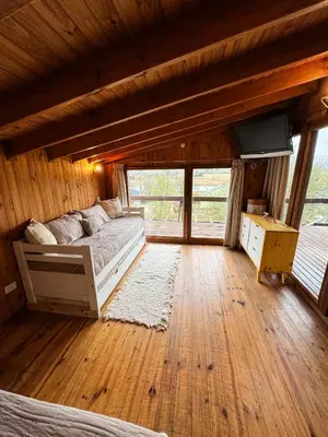 a bedroom with a bed and a television in a cabin at Casa Mona in Potrero de Garay