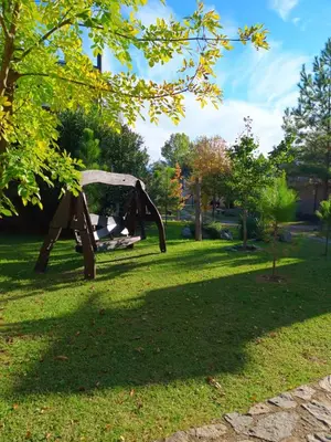a park with a bench in the grass at Las Lechuzas Complejo in Santa Rosa de Calamuchita