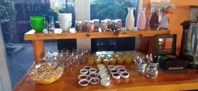 a counter with a bunch of cups and jars at Las Lechuzas Complejo in Santa Rosa de Calamuchita