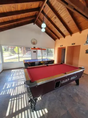 a room with a pool table in a room at Las Lechuzas Complejo in Santa Rosa de Calamuchita