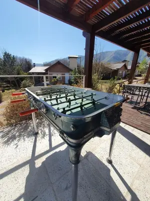 a ping pong table sitting on top of a patio at Las Lechuzas Complejo in Santa Rosa de Calamuchita