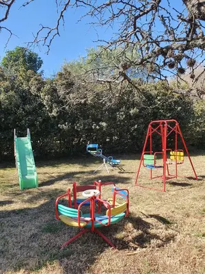 a group of playground equipment in a field at Las Lechuzas Complejo in Santa Rosa de Calamuchita