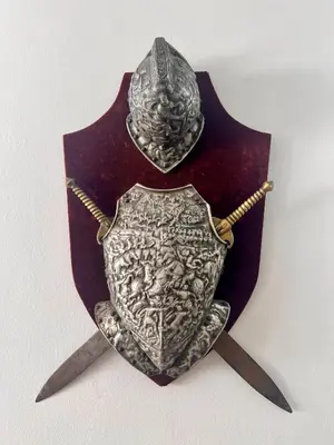 a shield and two swords on top of a book at Departamentos Refugio del Rio in Cordoba