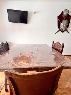 a dining room with a table covered in plastic at Departamentos Refugio del Rio in Cordoba