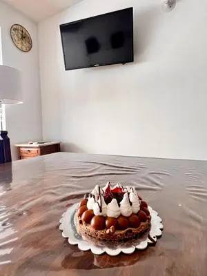 a cake sitting on top of a table at Departamentos Refugio del Rio in Cordoba