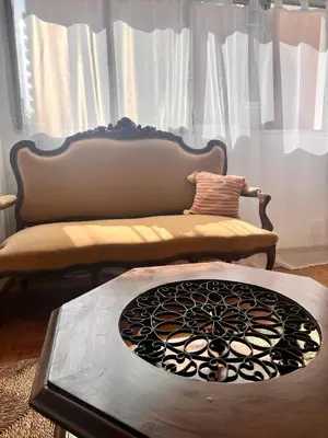 a living room with a couch and a table at Departamentos Refugio del Rio in Cordoba